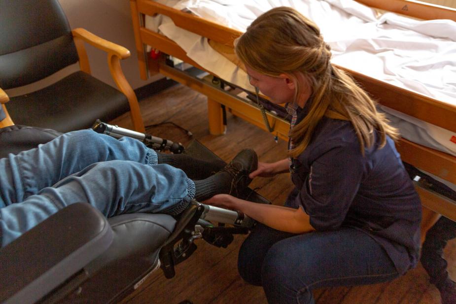 Verzorgende IG helpt client met aankleden